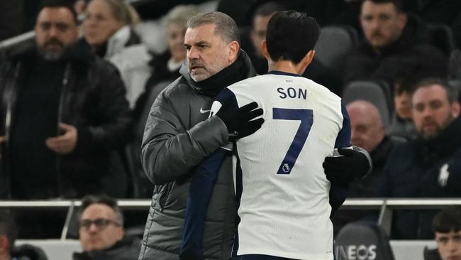 Tottenham Hotspur's Greek-Australian Head Coach Ange Postecoglou (L) gestures to Tottenham Hotspur's South Korean striker #07 Son Heung-Min (R) as he leaves the game, substituted during the English Premier League football match between Tottenham Hotspur and Manchester United at the Tottenham Hotspur Stadium in London, on February 16, 2025. (Photo by Glyn KIRK / AFP) / RESTRICTED TO EDITORIAL USE. No use with unauthorized audio, video, data, fixture lists, club/league logos or 'live' services. Online in-match use limited to 120 images. An additional 40 images may be used in extra time. No video emulation. Social media in-match use limited to 120 images. An additional 40 images may be used in extra time. No use in betting publications, games or single club/league/player publications. /