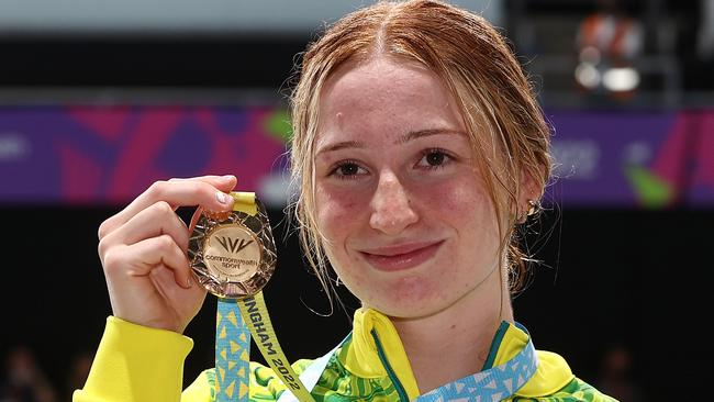 Mollie O'Callaghan shows off her gold medal after winning the 100m freestyle. Picture: Michael Klein