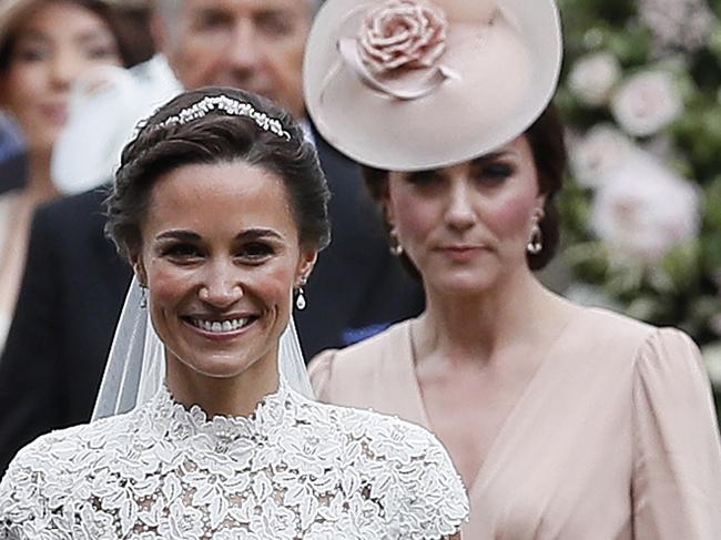 Kate, Duchess of Cambridge, right, follows the bride, her sister Pippa Middleton, after her wedding to James Matthews at St Mark's Church in Englefield, England Saturday, May 20, 2017. Middleton, the sister of Kate, Duchess of Cambridge married hedge fund manager James Matthews in a ceremony Saturday where her niece and nephew Prince George and Princess Charlotte was in the wedding party, along with sister Kate and princes Harry and William. (AP Photo/Kirsty Wigglesworth, Pool)