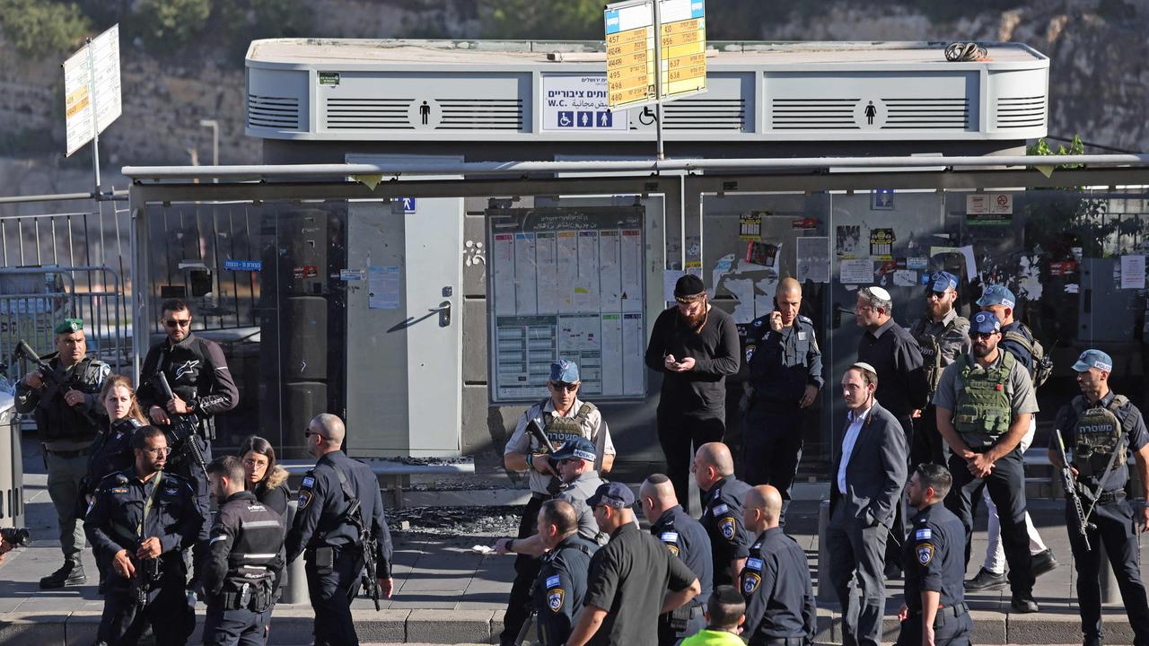 Israel's National Security Minister Itamar Ben-Gvir stands amid policemen and security guards as he inspects a shooting attack in Jerusalem on November 30, 2023. Picture: Ahmad Gharabli / AFP