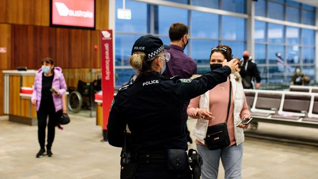 Police at Adelaide Airport after SA announced a border closure to NT, WA, QLD and the ACT. Picture: Morgan Sette)