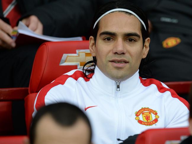 Manchester United's Colombian striker Radamel Falcao smiles on the bench before the English Premier League football match between Manchester United and Hull City at Old Trafford in Manchester, north west England, on November 29, 2014. AFP PHOTO / OLI SCARFF RESTRICTED TO EDITORIAL USE. No use with unauthorized audio, video, data, fixture lists, club/league logos or “live” services. Online in-match use limited to 45 images, no video emulation. No use in betting, games or single club/league/player publications.