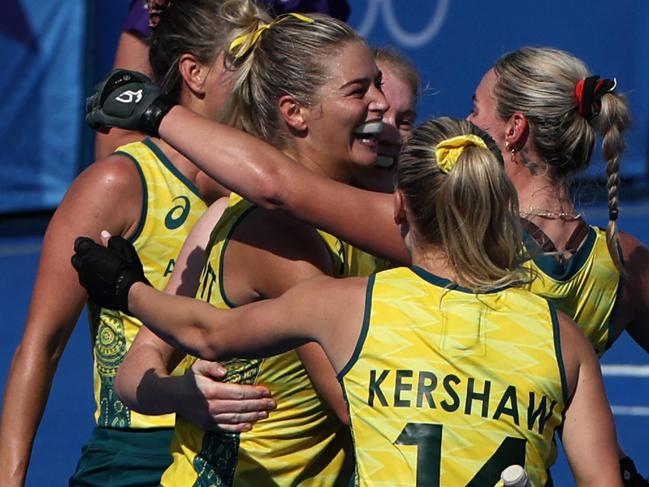 Australia's forward #11 Alice Arnott celebrates with teammates after scoring their second goal in the women's pool B field hockey match between Britain and Australia during the Paris 2024 Olympic Games at the Yves-du-Manoir Stadium in Colombes on July 29, 2024. (Photo by Ahmad GHARABLI / AFP)