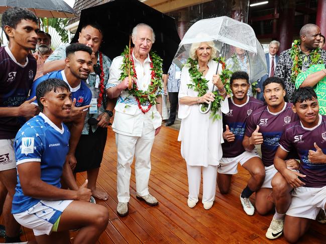 APIA, SAMOA - OCTOBER 24: King Charles III and Queen Camilla pose with local rugby union playersduring their Samoa Cultural Village visit on October 24, 2024 in Apia, Samoa. The King's visit to Australia is his first as monarch, and the Commonwealth Heads of Government Meeting (CHOGM) in Samoa will be his first as head of the Commonwealth. (Photo by Chris Jackson/Getty Images)