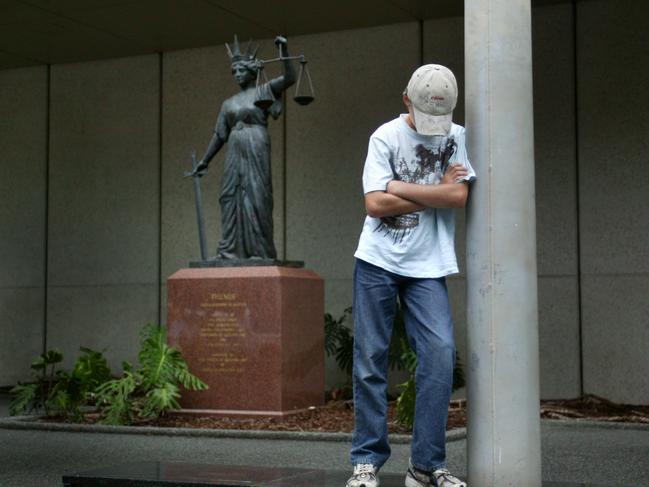 Generic of juvenile crime with young teenage boy sitting outside the court with scales of justice in background.