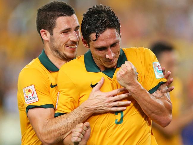 Mark Milligan and Mathew Leckie celebrate.