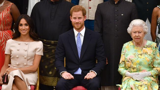 Harry and Meghan with Queen Elizabeth II at the Queen's Young Leaders Awards Ceremony at Buckingham Palace in 2018. Picture: Getty Images.