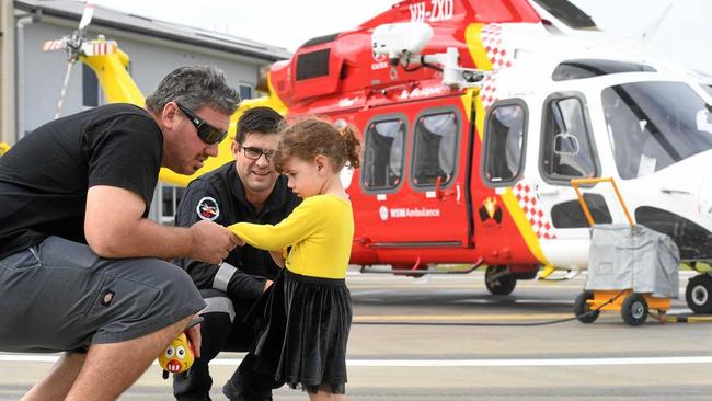 SPREADING THE LOVE: Josh and Bella Joy Cleary meet with Westpac Life Saver Rescue Helicopter pilot John Walker after donating money to the lifesaving organisation which airlifted Mr Cleary's wife Renee to the Gold Coast following a brain haemorrhage. Picture: Marc Stapelberg