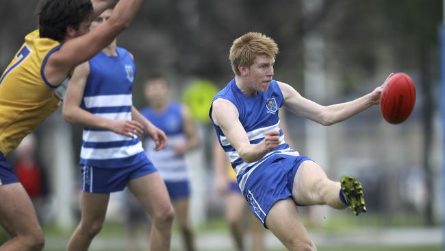 St Peter’s Matthew Roberts clears the ball from defence. Shortly later he kicked two goals. Picture: AAP/Dean Martin