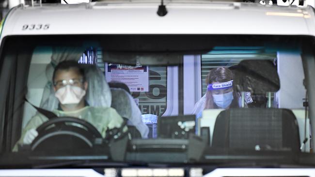 An ambulance crew transports a quarantined guest from the Grand Chancellor. Picture: NCA NewsWire/Dan Peled