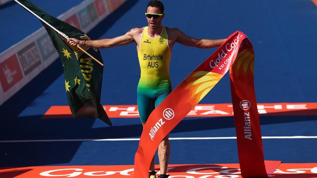 Jake Birtwhistle crosses the line to win gold in the triathlon mixed team relay on day three of the Gold Coast 2018 Commonwealth Games. Picture: CHRIS HYDE/GETTY IMAGES