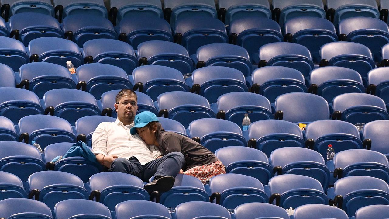 We don’t blame this fan for having a nap during some post-midnight tennis. (Photo by Quinn Rooney/Getty Images)