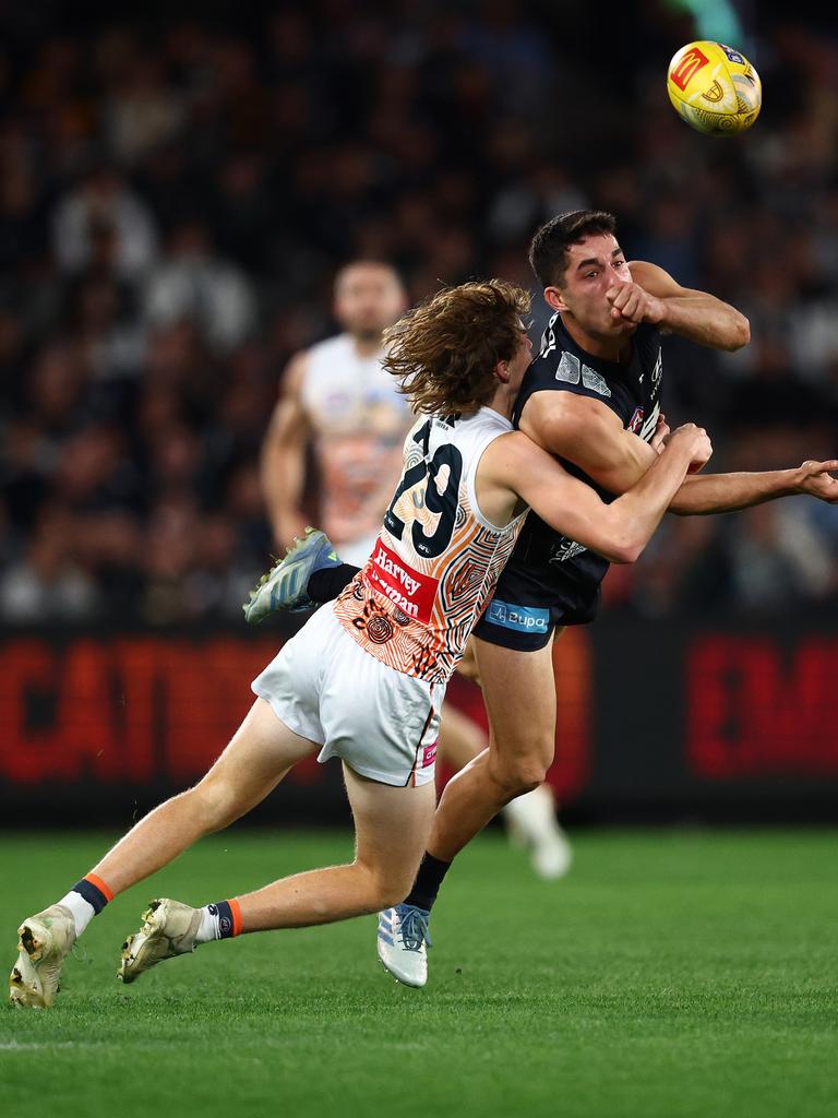 Adam Cerra gets the ball under serious Giants pressure. Picture: Morgan Hancock/Getty Images