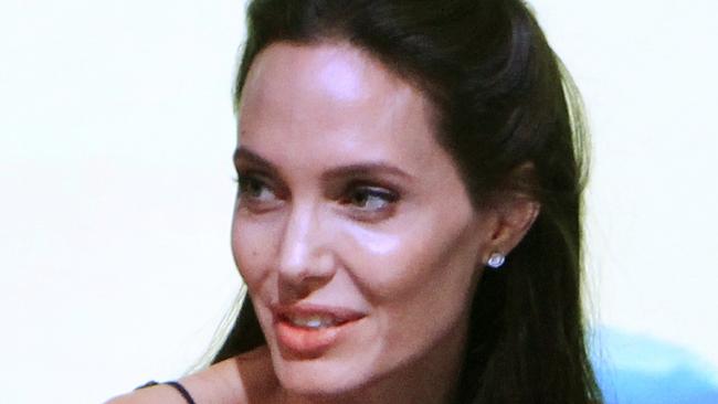 FILE - In this Dec. 5, 2015, file photo, actress Angelina Jolie Pitt talks during the Cambodia International Film Festival in Phnom Penh, Cambodia. Angelina Jolie Pitt first came to Cambodia 16 years ago to film “Lara Croft: Tomb Raider,” - the gun-toting, bungee-jumping, supremely toned action hero that made her a star. She’s back now for another movie, “First They Killed My Father,” as a director, and the subject matter is a far cry from Lara Croft. (AP Photo/Heng Sinith, File)