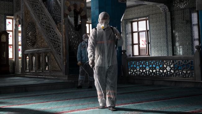 IA worker from Istanbul Municipality disinfects a mosque to prevent the spread of the COVID-19 coronavirus ahead of Friday prayers on March 13, 2020 in Istanbul, Turkey. Picture: Chris McGrath/Getty Images