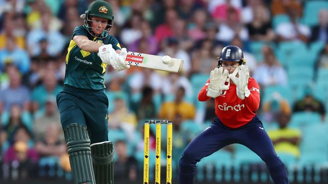 Beth Mooney hits hard down the ground against England. (Photo by Jeremy Ng/Getty Images)