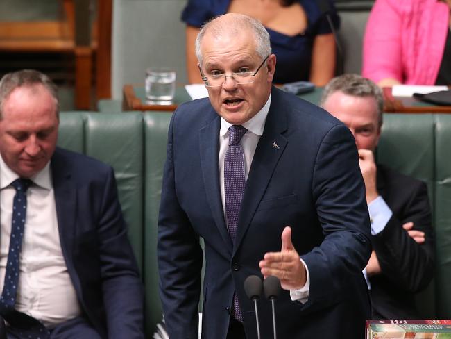 Treasurer Scott Morrison has smacked down Tony Abbott’s proposal to cut the immigration rate. Picture: AAP