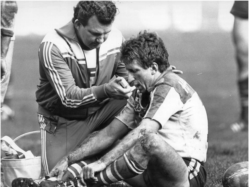 Steve Mortimer is treated by a Bulldogs trainer.