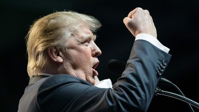 (FILES) This file photo taken on May 5, 2016 shows US Republican presidential candidate Donald Trump speaking during a rally in Charleston, West Virginia. Donald Trump said on November 9, 2016 he would bind the nation's deep wounds and be a president "for all Americans," as he praised his defeated rival Hillary Clinton for her years of public service. / AFP PHOTO / Brendan Smialowski