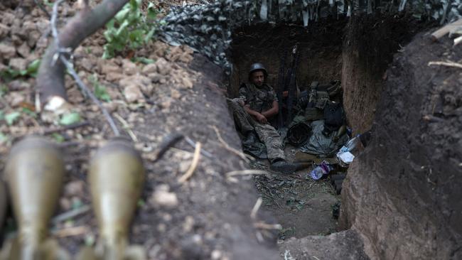 A Ukrainian soldier sits in a foxhole at a position along the front line in the Donetsk region. Picture: AFP