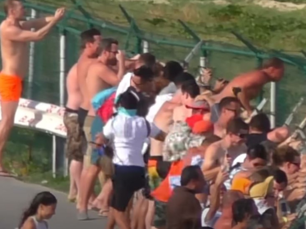 Crowds gather to hang off the fence. Picture: YouTube