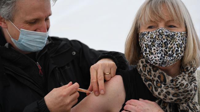 Health workers administer Covid-19 vaccines at a drive-through centre at Batchwood Hall in St Albans, north of London. Picture: AFP