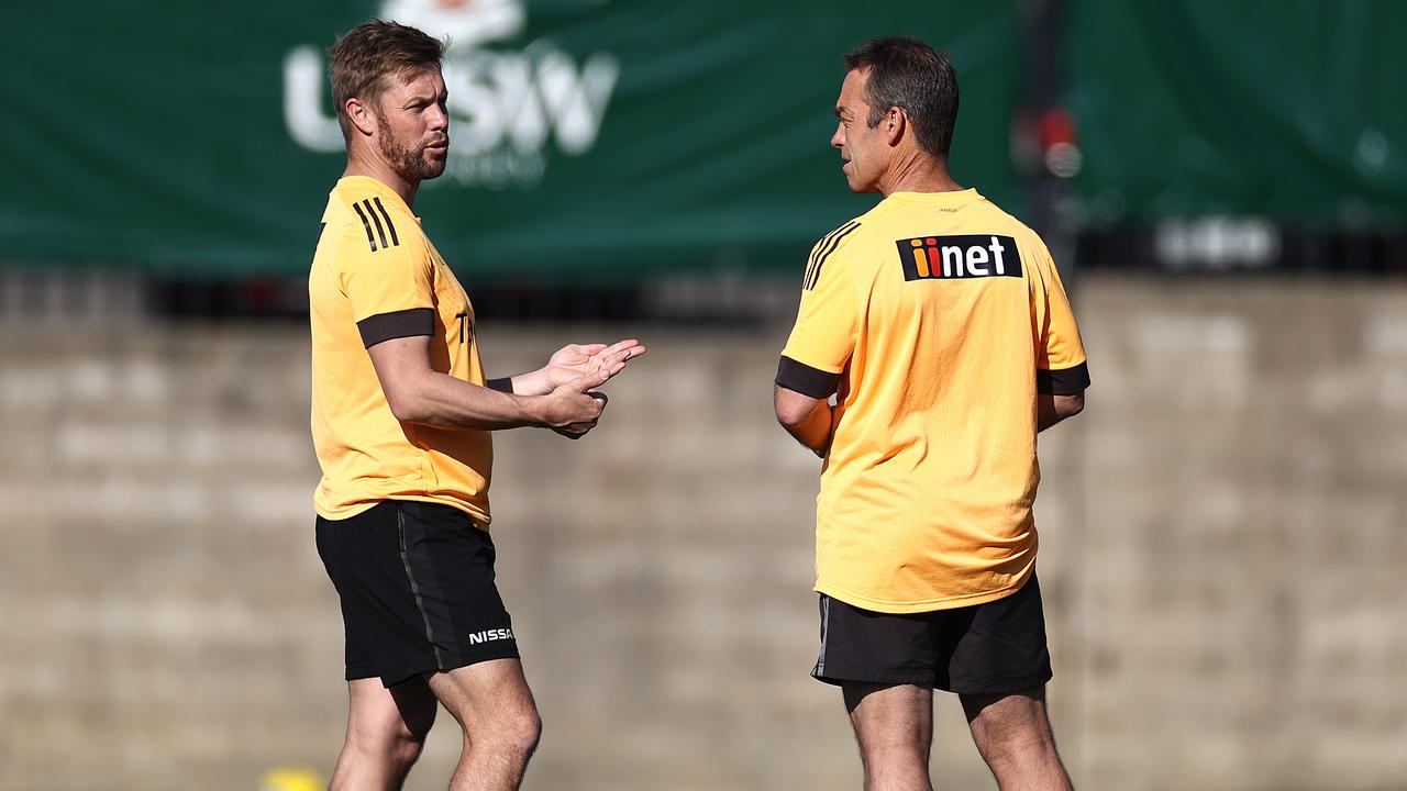 SYDNEY, AUSTRALIA - JULY 24: Alastair Clarkson, coach of the Hawks, speaks with Hawks Assistant Coach Sam Mitchell during a Hawthorn Hawks AFL Captains Run at Coogee Oval on July 24, 2020 in Sydney, Australia. (Photo by Ryan Pierse/Getty Images)