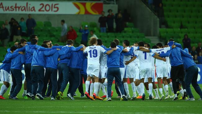 Uzbekistan players go wild after the full time whistle in Melbourne.