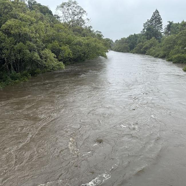 Enoggera Creek, pictured in Wilston, is close to breaking its banks.