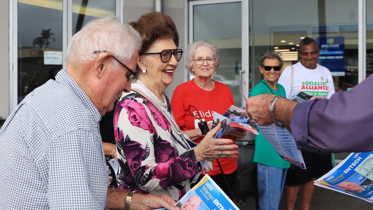 Barry Muir and Nora Farrelly accept a how to vote card for Member from Leichhardt Warren Entsch at the pre polling booth at DFO Cairns, Westcourt. Picture: Brendan Radke