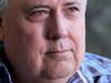 Clive Palmer talks to the media on the Esplanade at Paradise Point, Gold Coast. Pic Jono Searle.