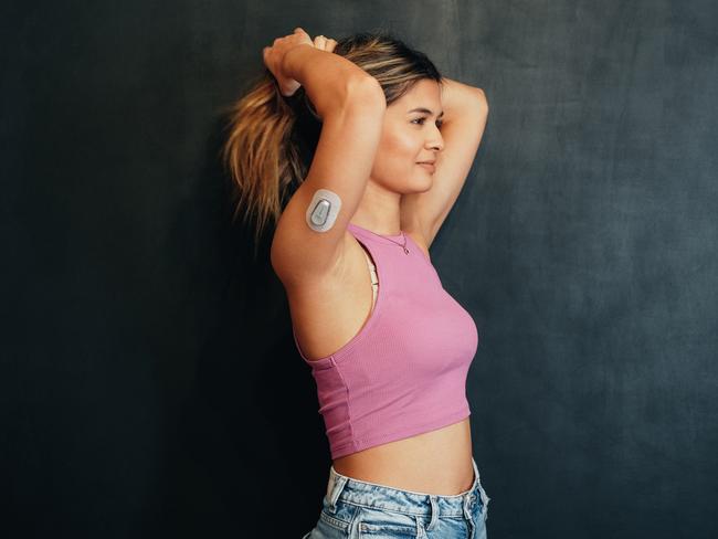 A woman with diabetes wearing a small sensor on the back of her upper arm for measuring glucose levels 24/7. Picture: iStock