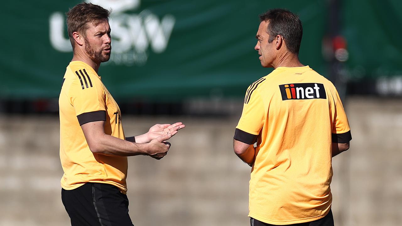 Hawks senior coach Clarkson (right) speaks with assistant coach Mitchell. Picture: Getty Images