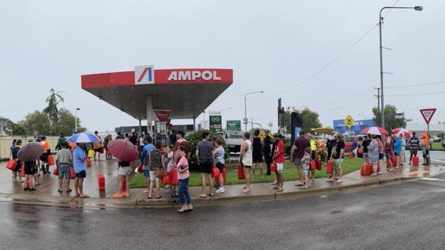 The huge line-up for fuel on Tuesday in Ingham after massive flooding has cut power and telecommunications. Photo: Cameron Bates.