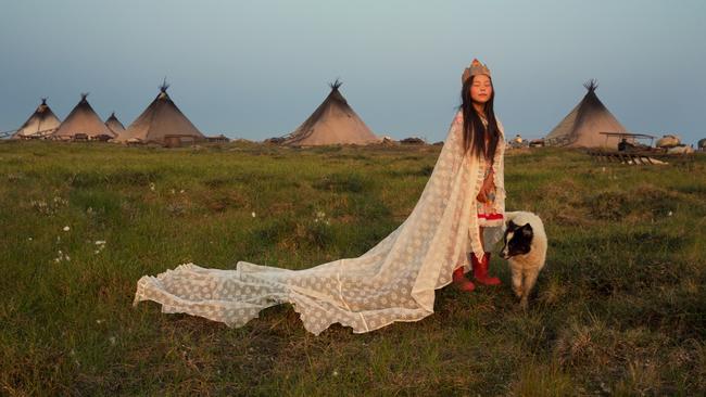 Christina, adorned with a curtain and a makeshift crown from a carton box, playfully poses as the Princess of Tundra in a Nenets reindeer herders’ camp. Picture: Evgenia Arbugaeva/Vital Impacts