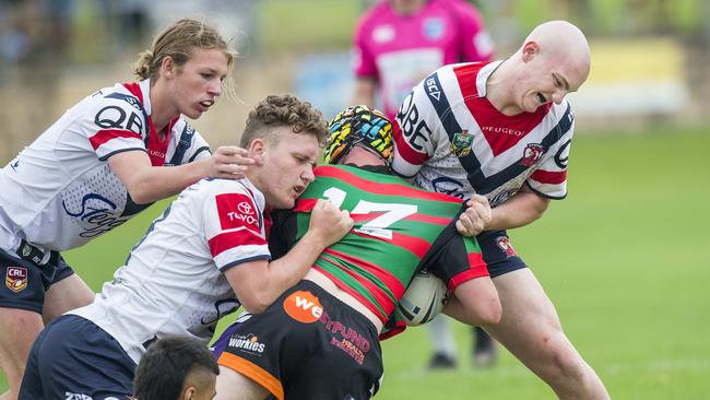 Central Coast Roosters players tackle a South Sydney player during their Harold Matthews rugby league match at Morry Breen Oval at Kanwal on Saturday. Picture: Troy Snook