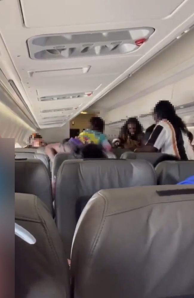 Australian Federal Police and NT Police arrested four passengers over an alleged brawl on a flight from Cairns to Darwin, via Groote Eylandt, on Thursday.