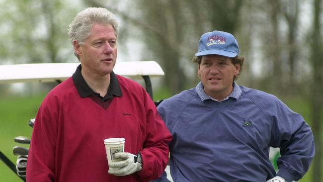 Brothers Bill and Roger Clinton take a break while playing golf in 2000. Picture: AP /Susan Walsh