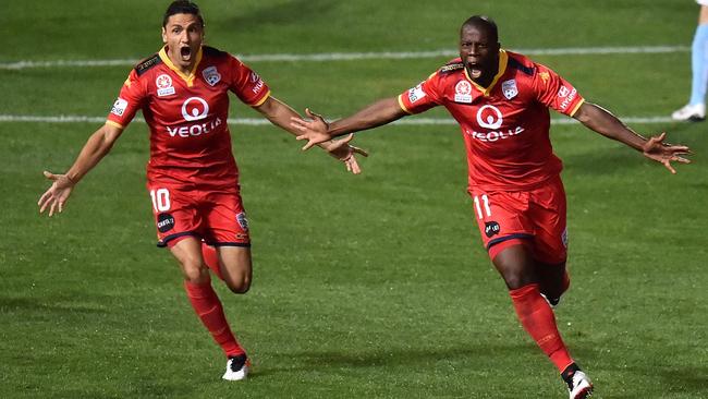 Marcelo Carrusca of United and Bruce Djite react after scoring a goal during the A-League Semi Final match between Adelaide United and Melbourne City in Adelaide in 2016. Picture: Daniel Kalisz/Getty Images