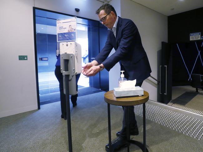 MELBOURNE, AUSTRALIA - JULY 17: Victorian Premier Daniel Andrews sanitises his hands after speaking to the media at the daily briefing on July 17, 2020 in Melbourne, Australia. Victoria has recorded 428 new cases of coronavirus overnight and three new deaths, bringing the total number of deaths in the state from COVID-19 to 32. Metropolitan Melbourne and the Mitchell shire are currently in lockdown following the rise in COVID-19 cases through community transmissions. The new restrictions came into effect on Thursday 9 July, with residents in lockdown areas under stay at home orders until 19 August. People are only able to leave home have for exercise or work, to buy essential items including food or to access childcare and healthcare. (Photo by Darrian Traynor/Getty Images)