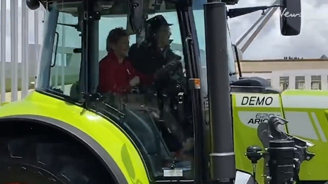 Pauline Hanson drives a tractor outside Parliament House