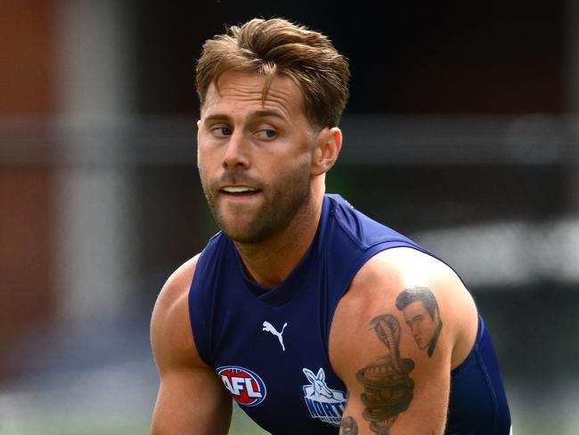 MELBOURNE, AUSTRALIA - DECEMBER 09: Caleb Daniel of the Kangaroos handballs during a North Melbourne Kangaroos AFL training session at Arden Street Ground on December 09, 2024 in Melbourne, Australia. (Photo by Quinn Rooney/Getty Images)