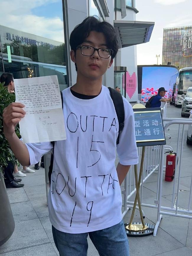 Xiao Sha, a superfan of Socceroo Harry Souttar, waiting for a glimpse of the Australian team as they shuttle between their Beijing hotel and training venue.