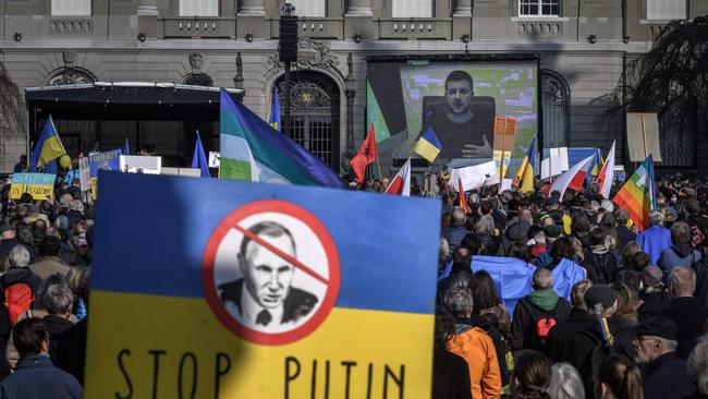 Ukrainian President Volodymyr Zelenskyy is displayed on a giant screen after he addressed a demonstration against the Russian invasion of Ukraine in front of the Swiss House of Parliament in Bern. Picture: Fabrice Coffrini / AFP)