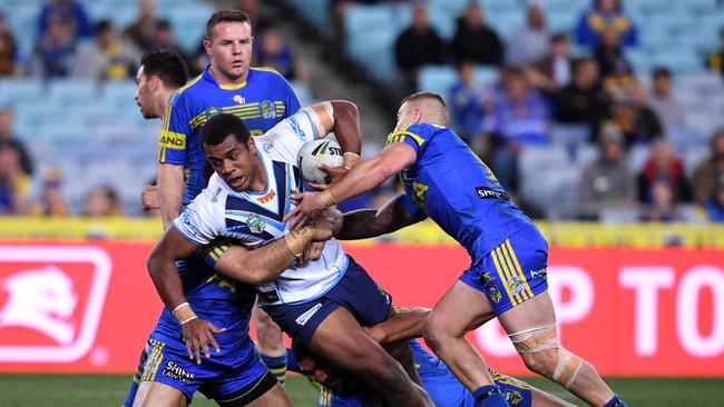 Ben Nakubuwai (centre) of the Titans is tackled by Suaia Matagi (left), Tepai Moeroa and Cameron King (right) of the Eels. Picture: AAP Image