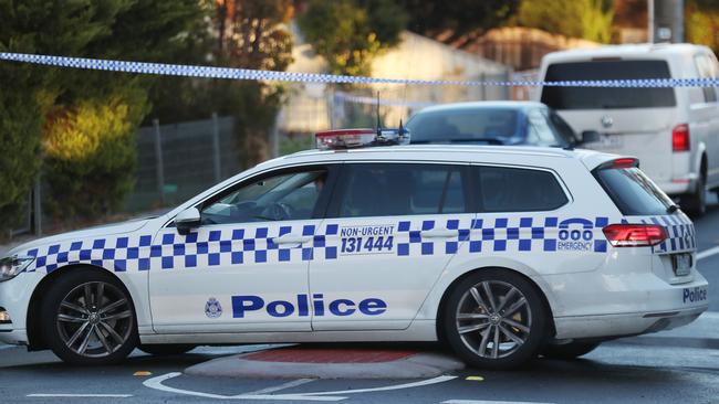 Police cordon off the street. Picture: David Crosling