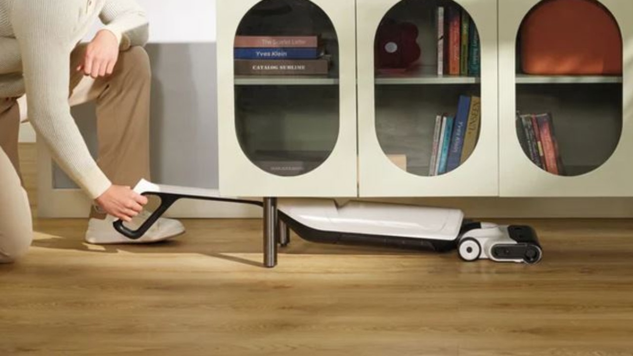 Roborock Flexi Lite Wet &amp; Dry Vacuum Cleaner using its FlatReach design to clean under furniture. Picture: Roborock