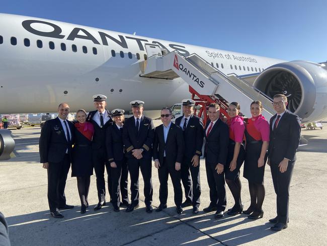 The Qantas crew celebrates at the end of the flight with CEO Alan Joyce.