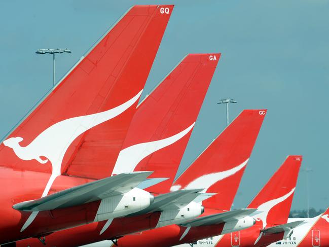 The tails of Qantas jets are seen at Sydney International Airport, Wednesday, Dec. 3, 2008. Qantas announced today, Tuesday, April 14, 2009 that more than 1500 jobs could go as it reduces capacity in the face of rapidly deteriorating trading conditions. The airline also slashed its full year pre-tax profit outlook to between $100 million and $200 million, down from its previous forecast of $500 million. (AAP Image/FILE/Dean Lewins) NO ARCHIVING