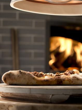 WOODFIRED: Pizza chefs prepare fresh bases every day.